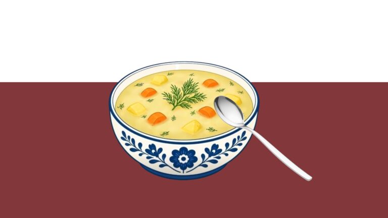 A blue and white bowl of soup with potatoes, dill, and carrots.